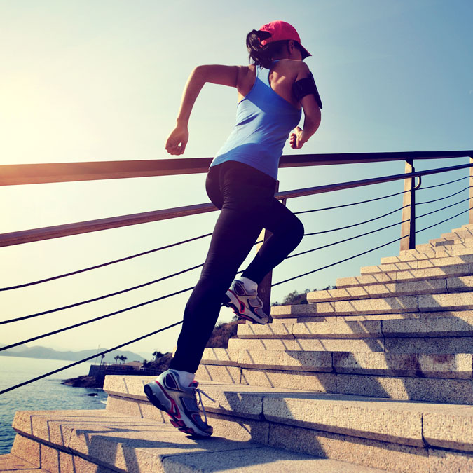woman running up stairs for exercise