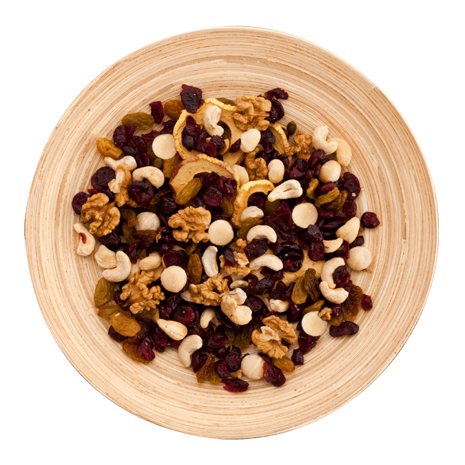 A bowl of healthy trail mix with macadamia nuts and dried fruit.